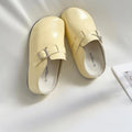 Women's flat buckle casual sneakers in yellow, creamy-white, silver, and black colours with round toe design