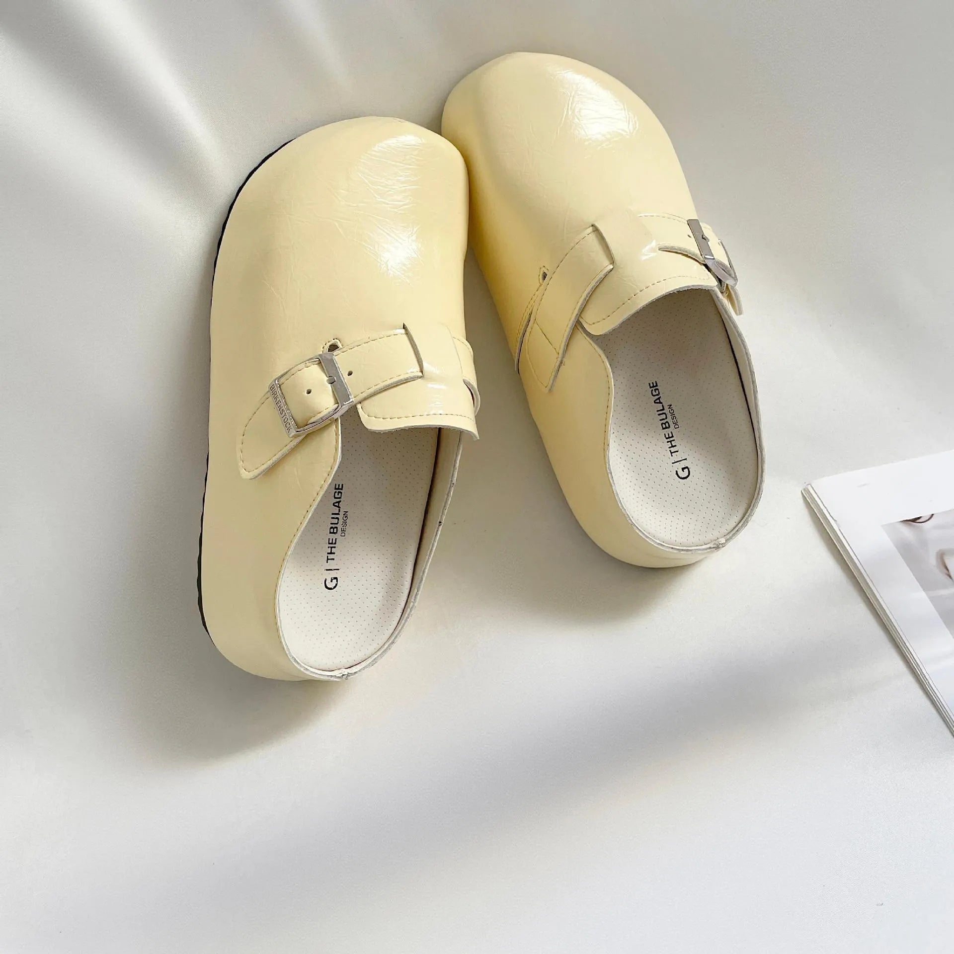 Women's flat buckle casual sneakers in yellow, creamy-white, silver, and black colours with round toe design