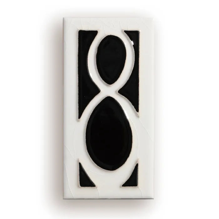 Handmade retro enamel ceramic doorplate showing a number on a glossy surface
