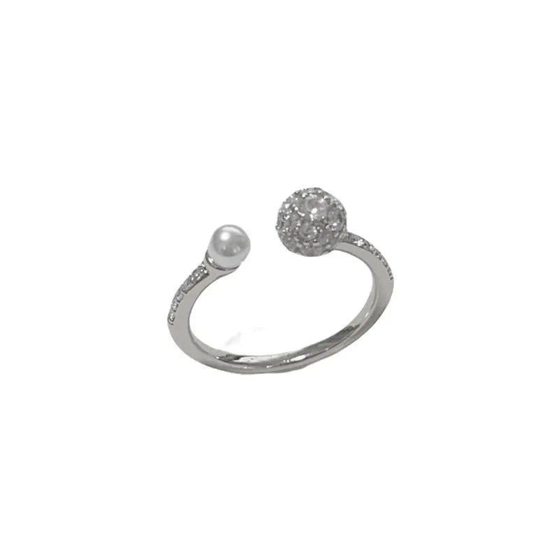 Gold and silver open-end women's ring with round zircon stones and pearl design on geometric band
