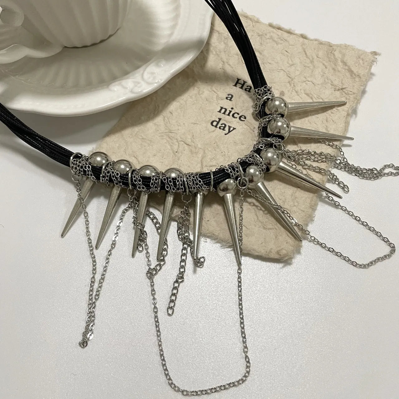 Women's casual leather necklace with electroplated round beads, rivet detailing, and winding tassel design
