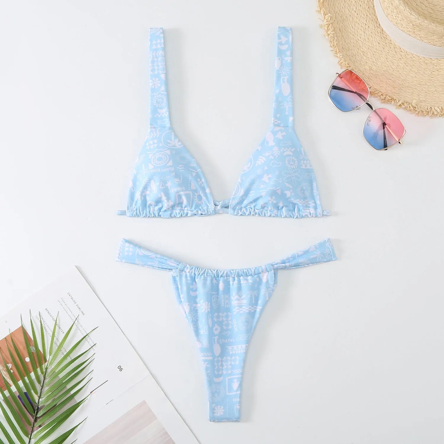 Women's blue floral print bikini top and briefs set on a white background