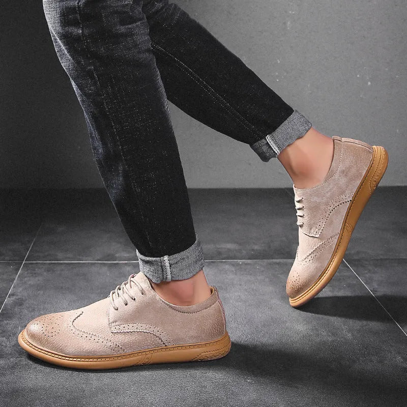 Men's black leather low-top lace-up business shoes with a rubber sole on a plain background.