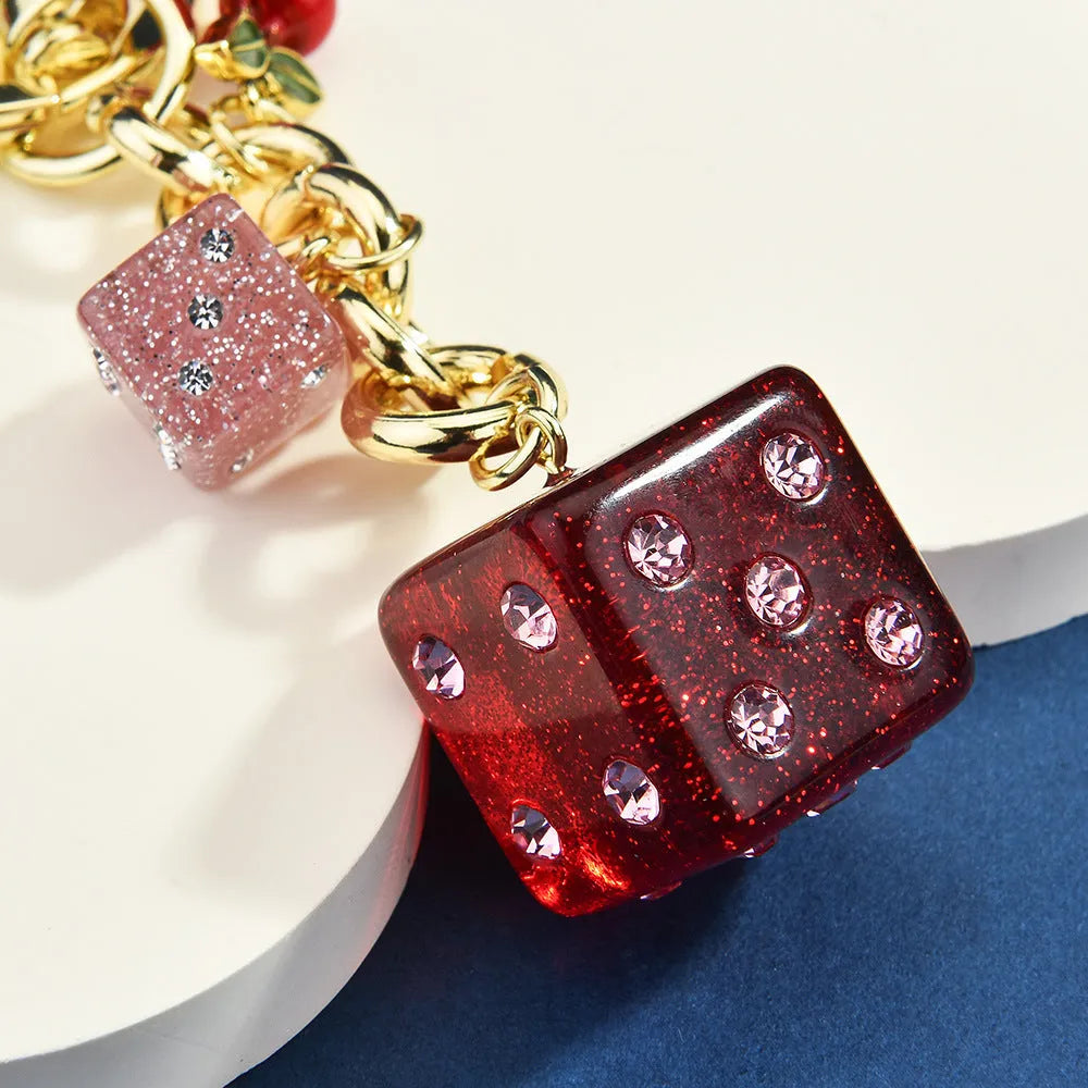 Square metal dice keychain pendant with cherry two-tone electroplated finish on a keyring