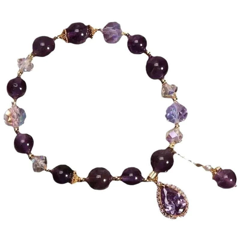 Close-up of a women's purple amethyst crystal bracelet with micro inlay detailing.