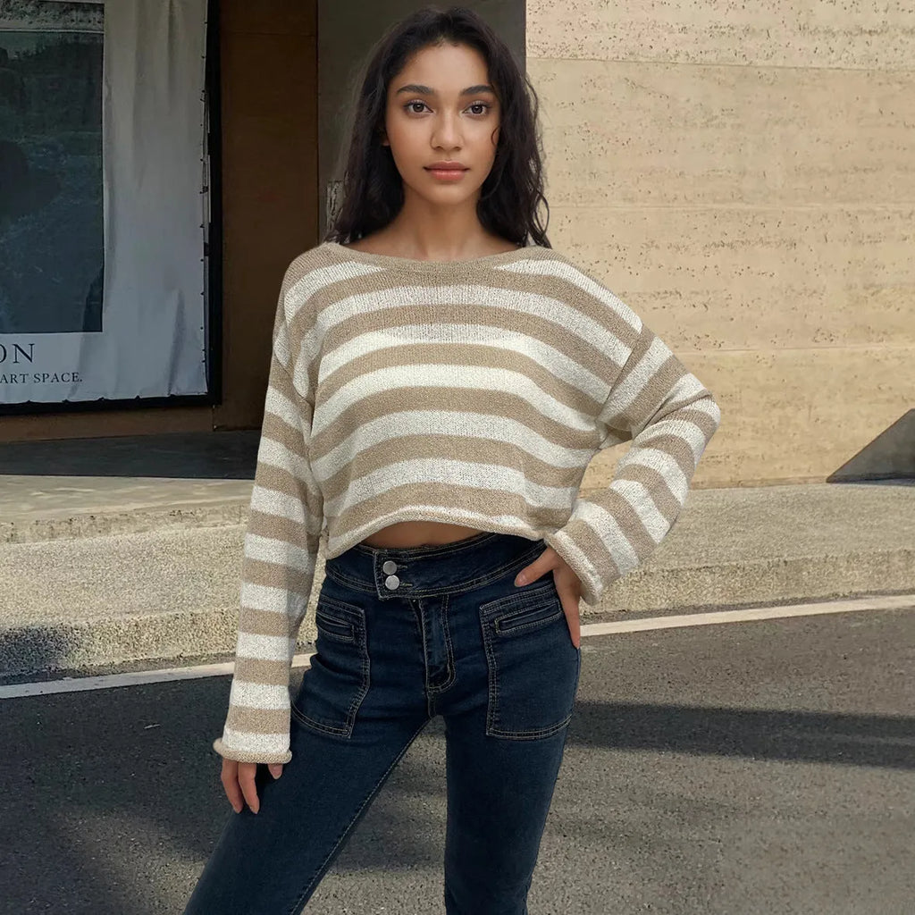 Woman wearing a striped long-sleeved cropped sweater in mercerised cotton, showcasing front and back wearable design.