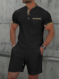 Men's grey waffle polo collar short sleeve suit top and shorts laid flat.