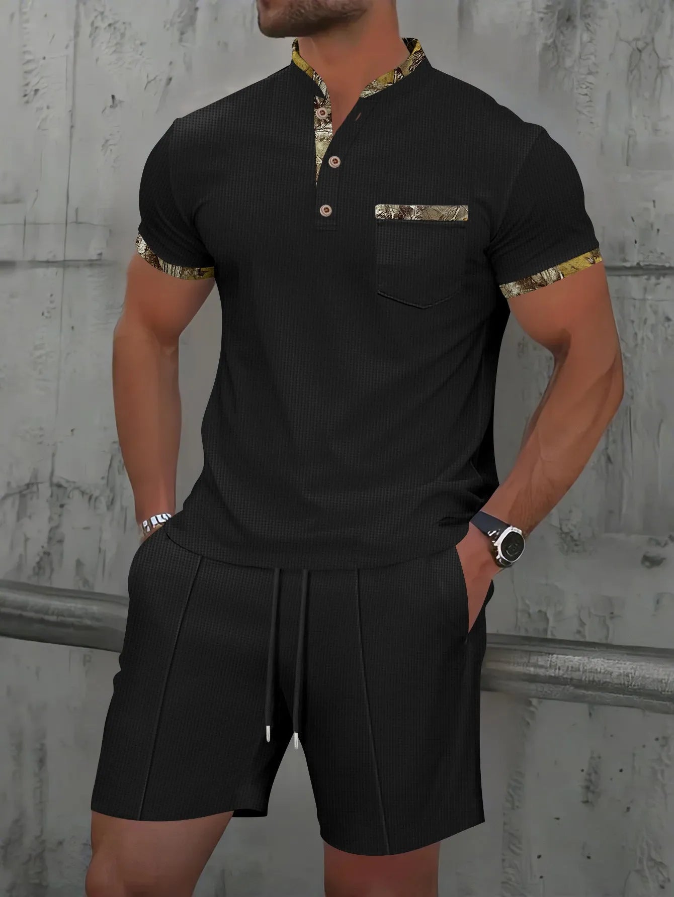 Men's grey waffle polo collar short sleeve suit top and shorts laid flat.