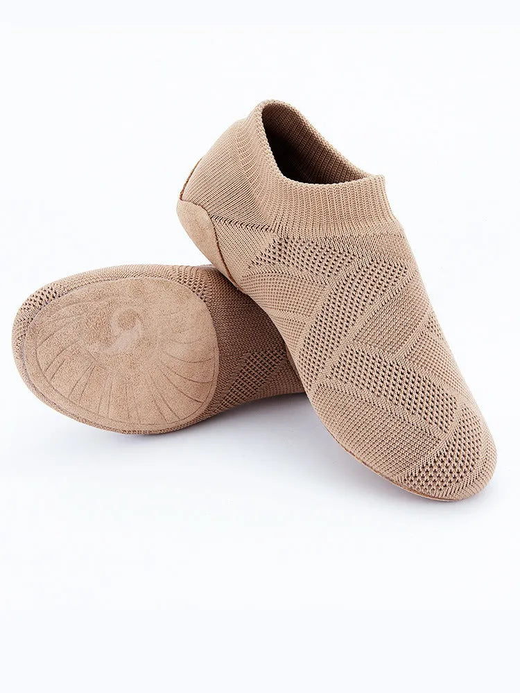 Camel coloured Latin dance shoes with cotton mesh upper and leather sole on a plain background.