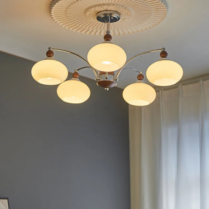 Creative persimmon glass chandelier with chrome frame and multiple glass shades in milky white or cream yellow.