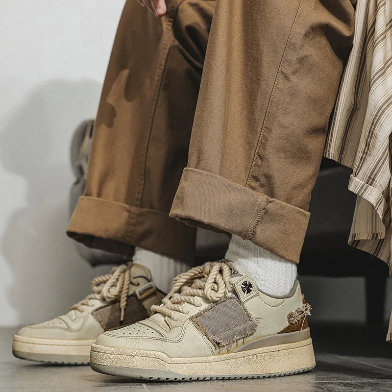 Beige vintage patch skateboard shoes with lace-up closure and low-top design