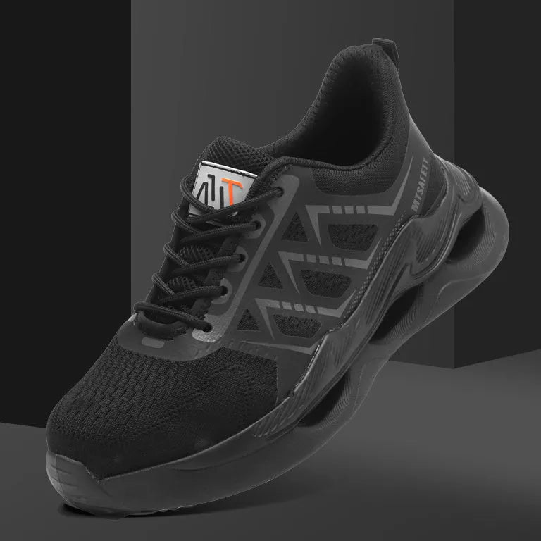 Black low-top safety shoes with a lace-up front, knitted upper, and a visible rubber sole with steel toe cap protection.