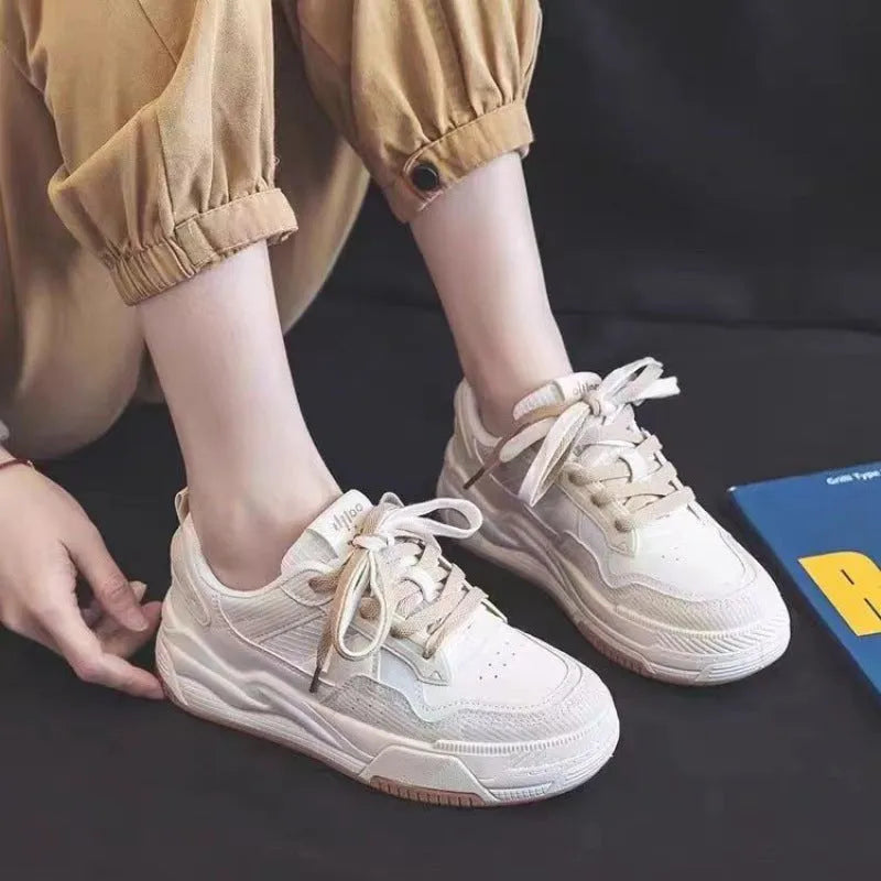 Pink and beige low-top sneakers with rubber soles and height-increasing design