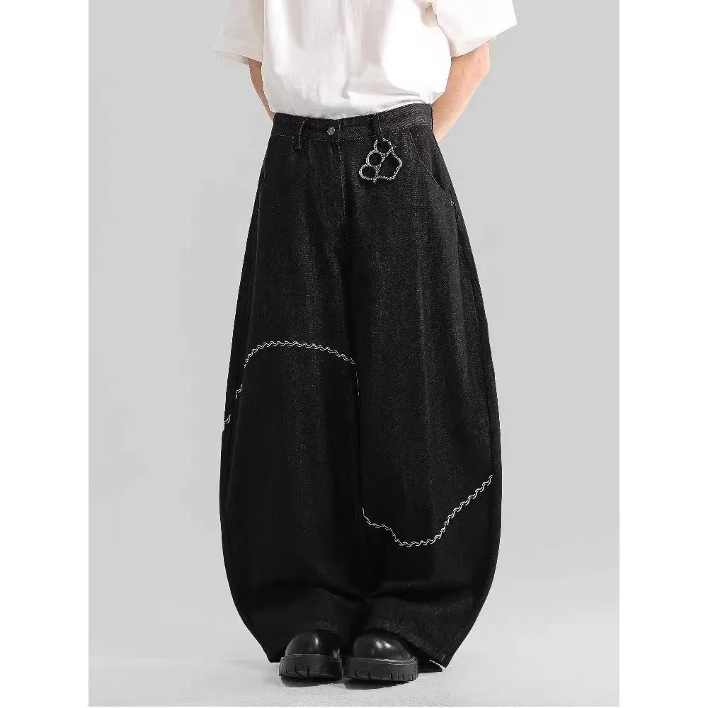Black straight-leg denim trousers with a mid-waist and zip fly, laid flat.