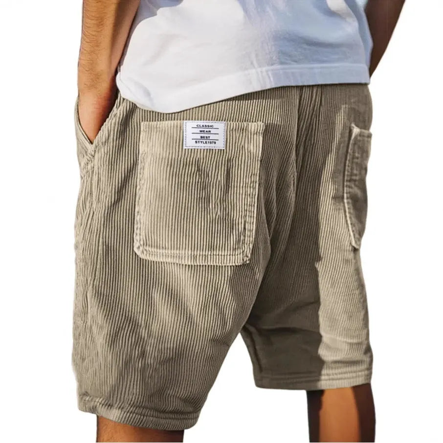 Men's grey straight-leg corduroy shorts with multiple pockets and embroidery detail on a hanger.