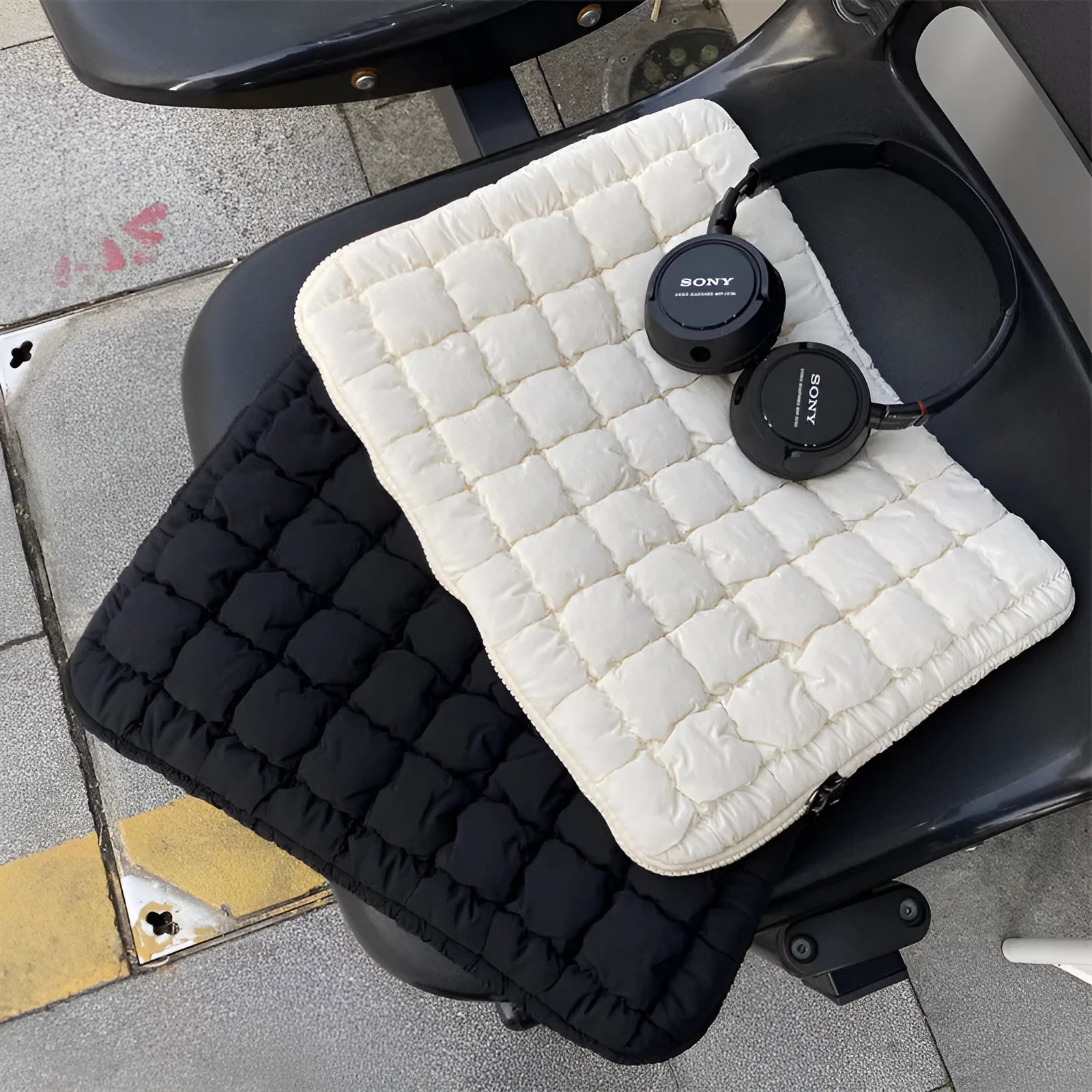 Black nylon laptop bag with cloud cotton interior padding shown next to a white version, sized for a 15.6-inch laptop.