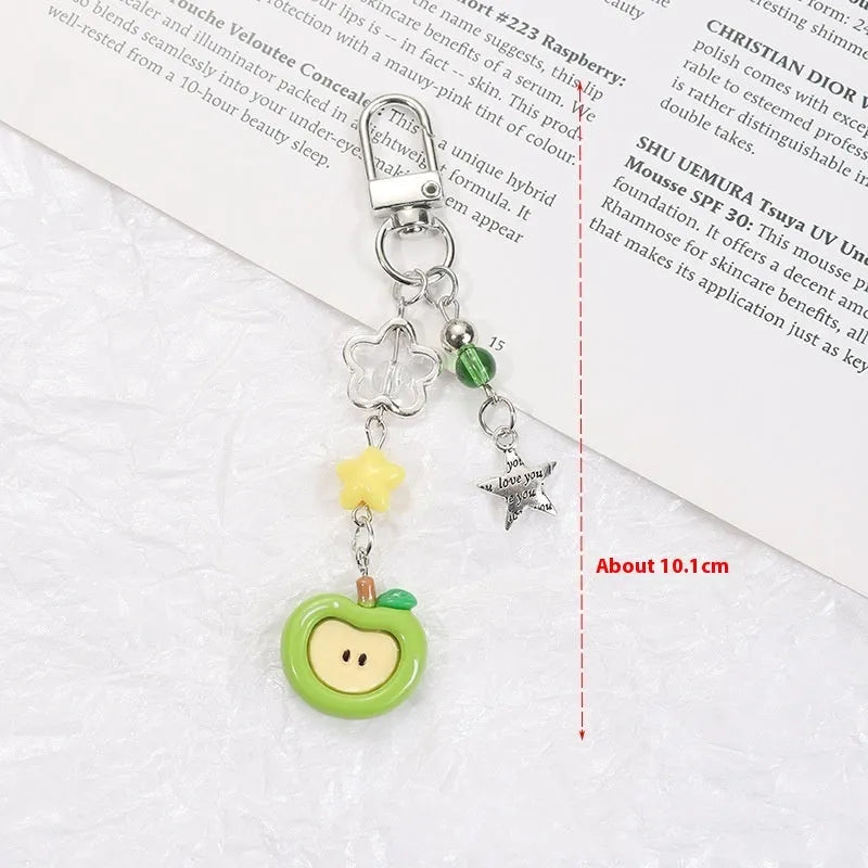 Plastic resin fruit phone charm keychain with strawberry design on white rope cord
