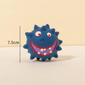 Set of four colourful latex squeaky dog balls with cute faces on bumpy textured surfaces