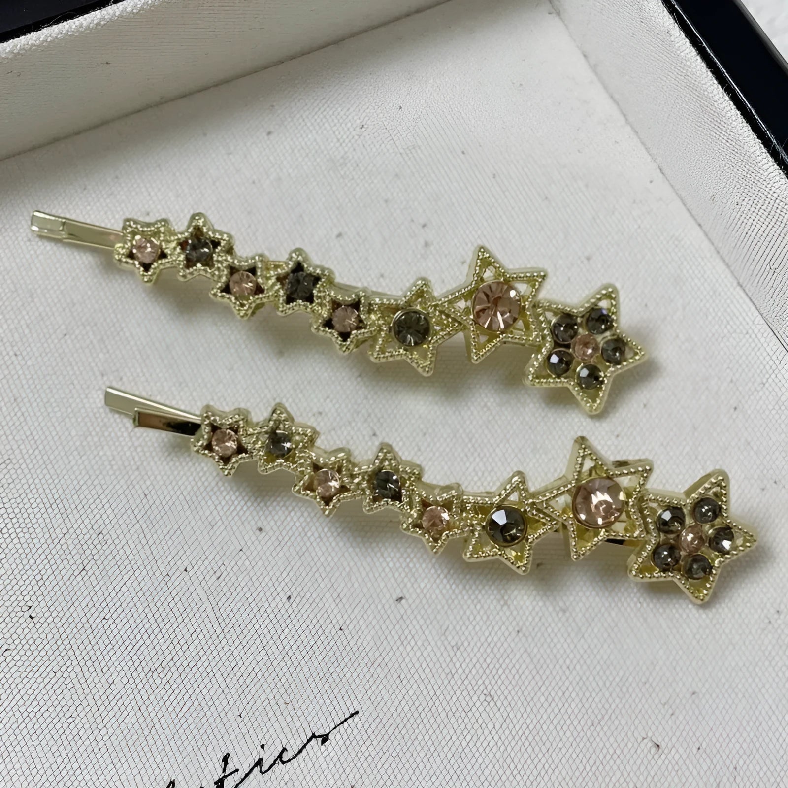 Golden electroplated hair barrette with star decoration and side clip design for bangs