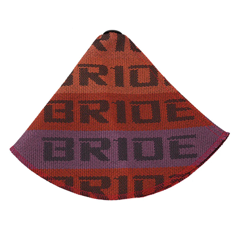 Canvas dust cover draped over a racing bucket seat in a vehicle interior.