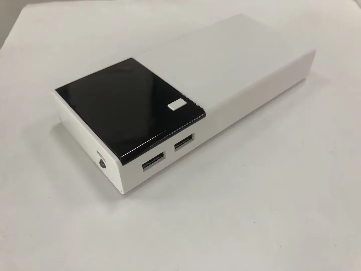 Black 20000mAh power bank with charging cable showing aluminium shell construction