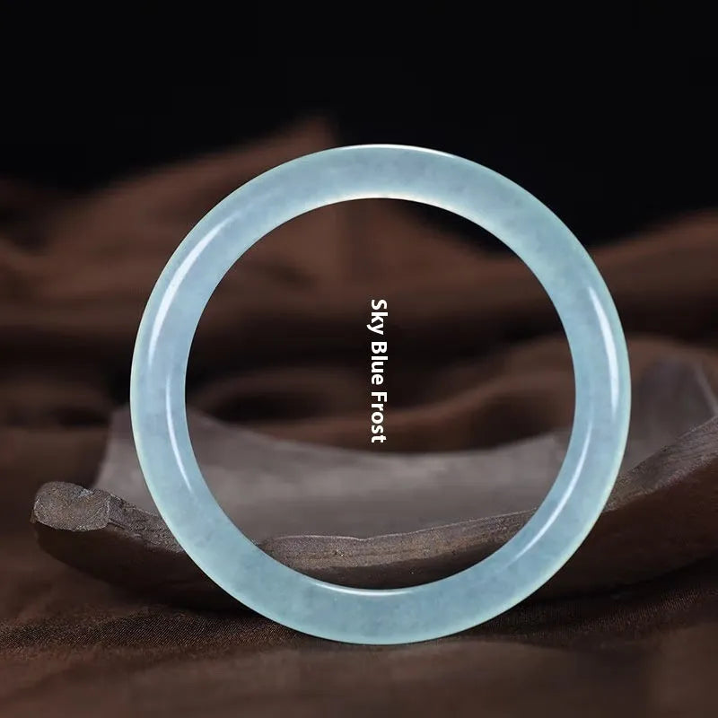 Azure light blue water ice quartzite jade thin round bar bracelet on white background
