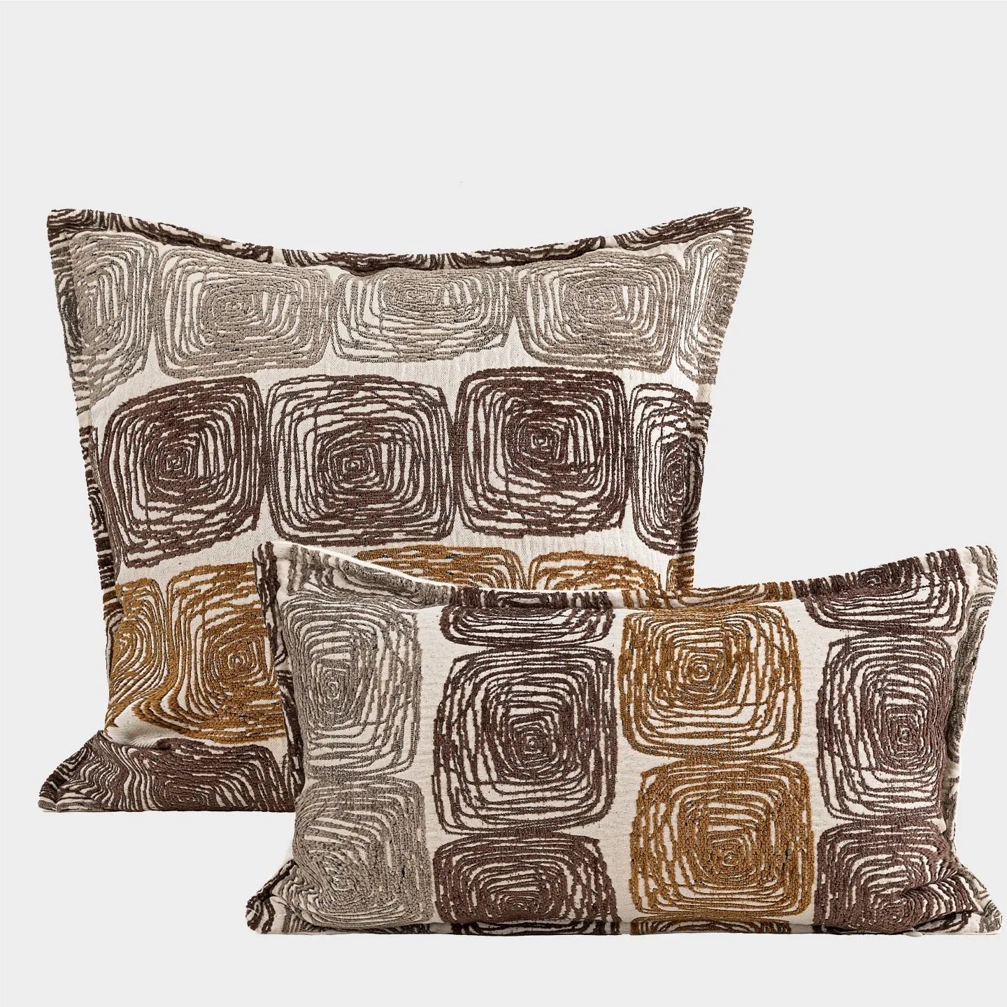 Abstract coil pattern pillow cover in cream and coffee colours on grey sofa
