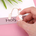 Creative cartoon metal pendant bookmark holder with cherry cat design.