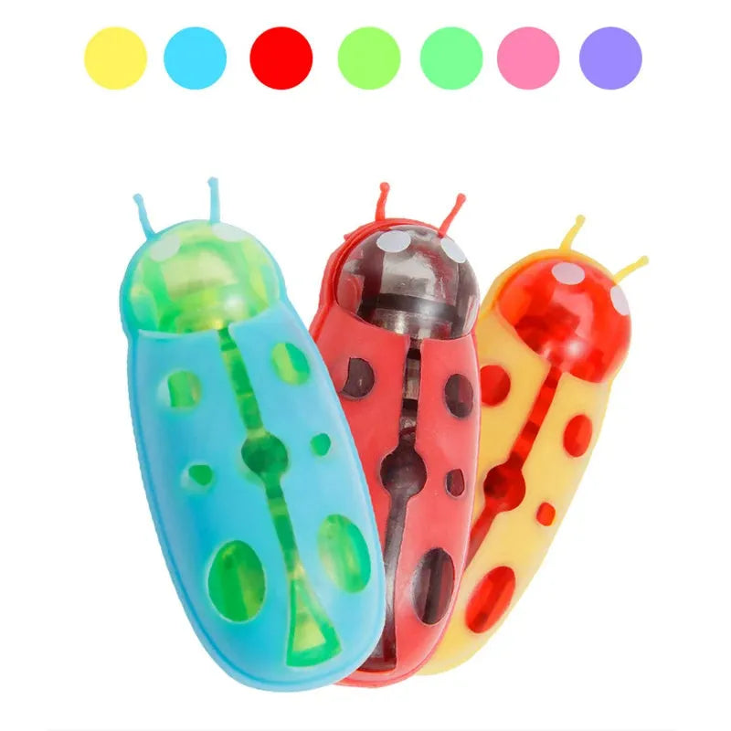 Small electric ladybug cat toy with 12 angular legs on hard floor surface