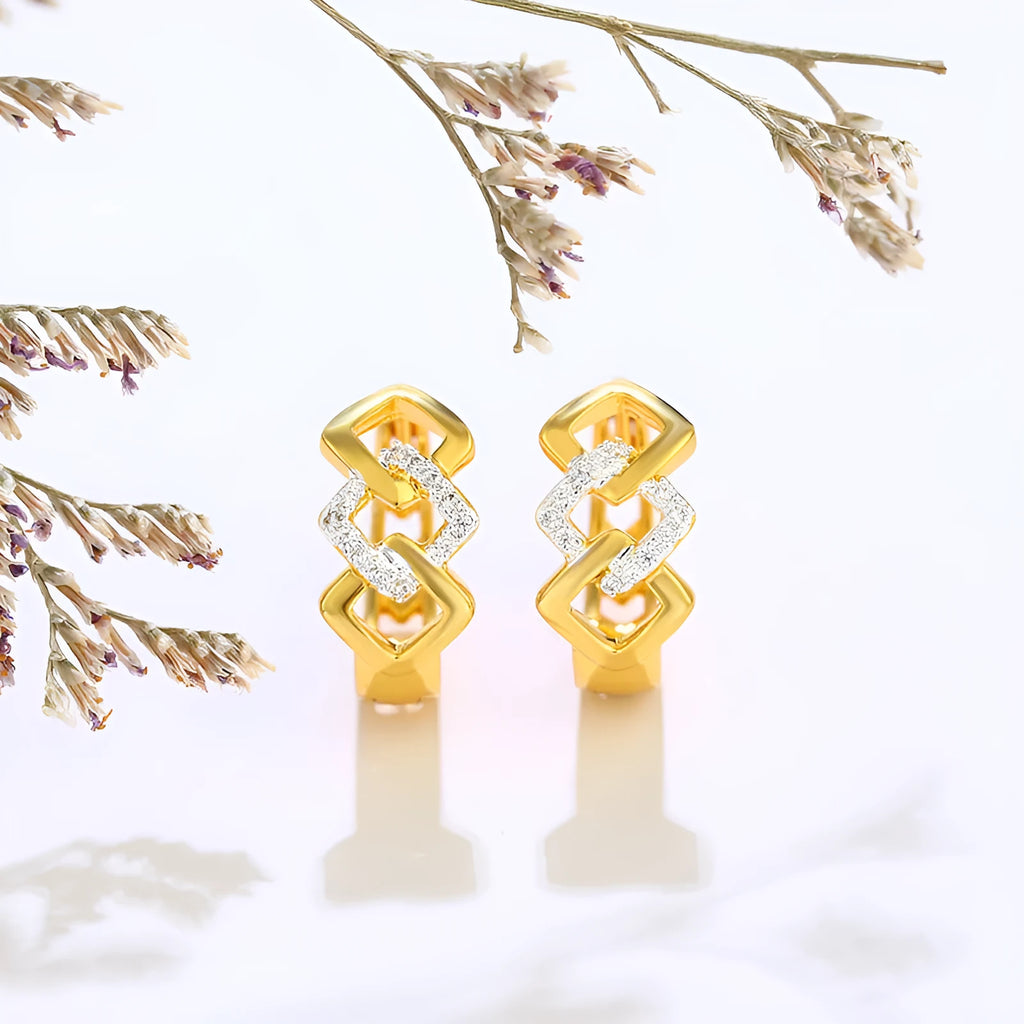 A pair of gold geometric earrings with a hollow out design and clip-on fastening.