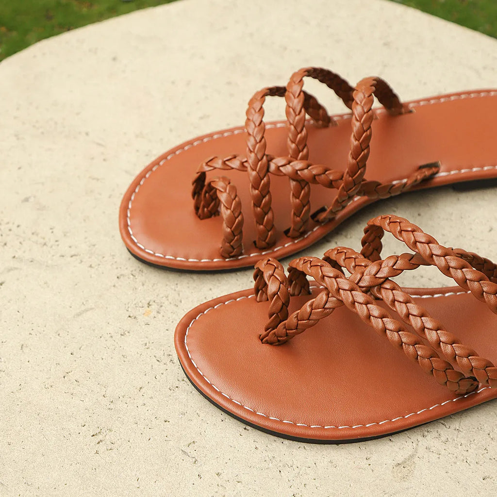 Women's brown woven clip-toe flat sandals on a white background