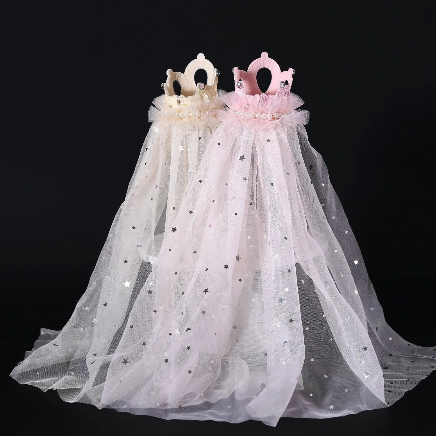 A cat wearing a princess crown headdress with a long, flowing veil for a wedding or celebration.