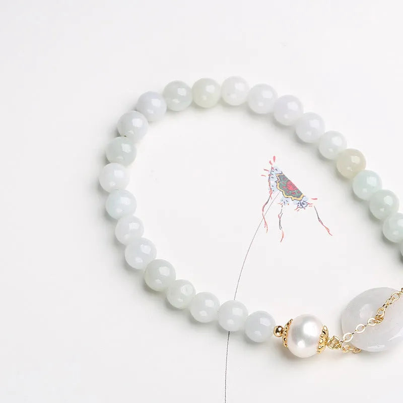 Natural emerald peace buckle pearl bracelet for women with jade round pendant on a geometric design.