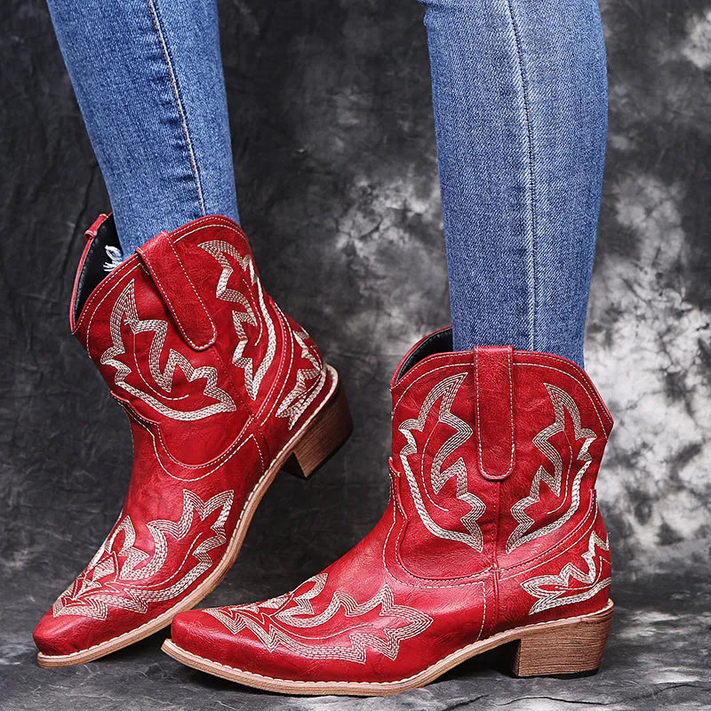 Blue women's cowboy boots with embroidery on the shaft and a low wedge heel.