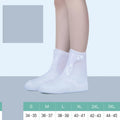 White high-top PVC reusable waterproof shoe covers for women with size chart showing measurements