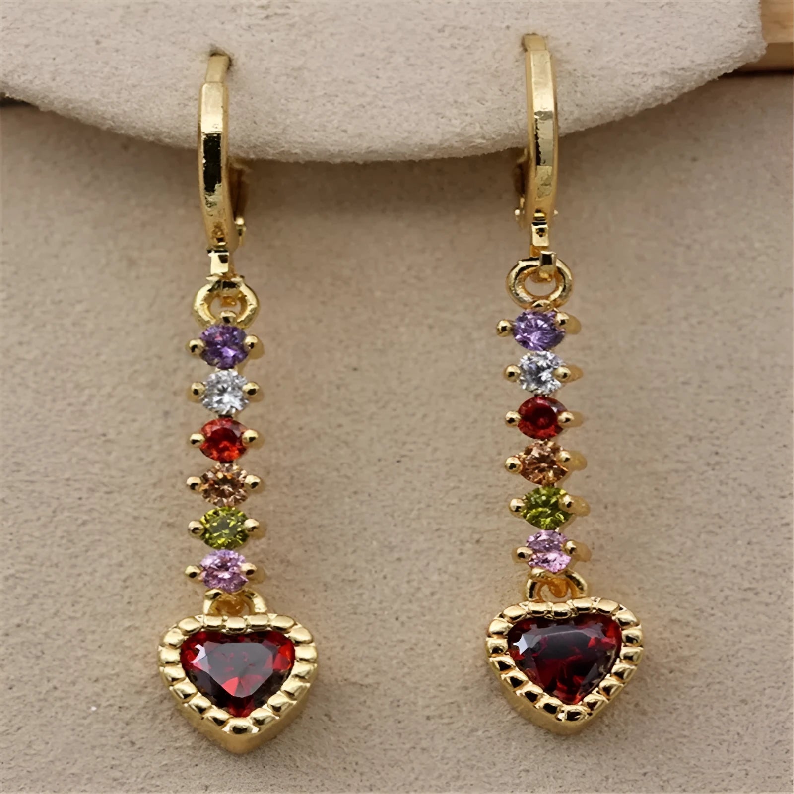 A pair of women's heart-shaped fashion earrings in a gold or silver alloy metal finish.