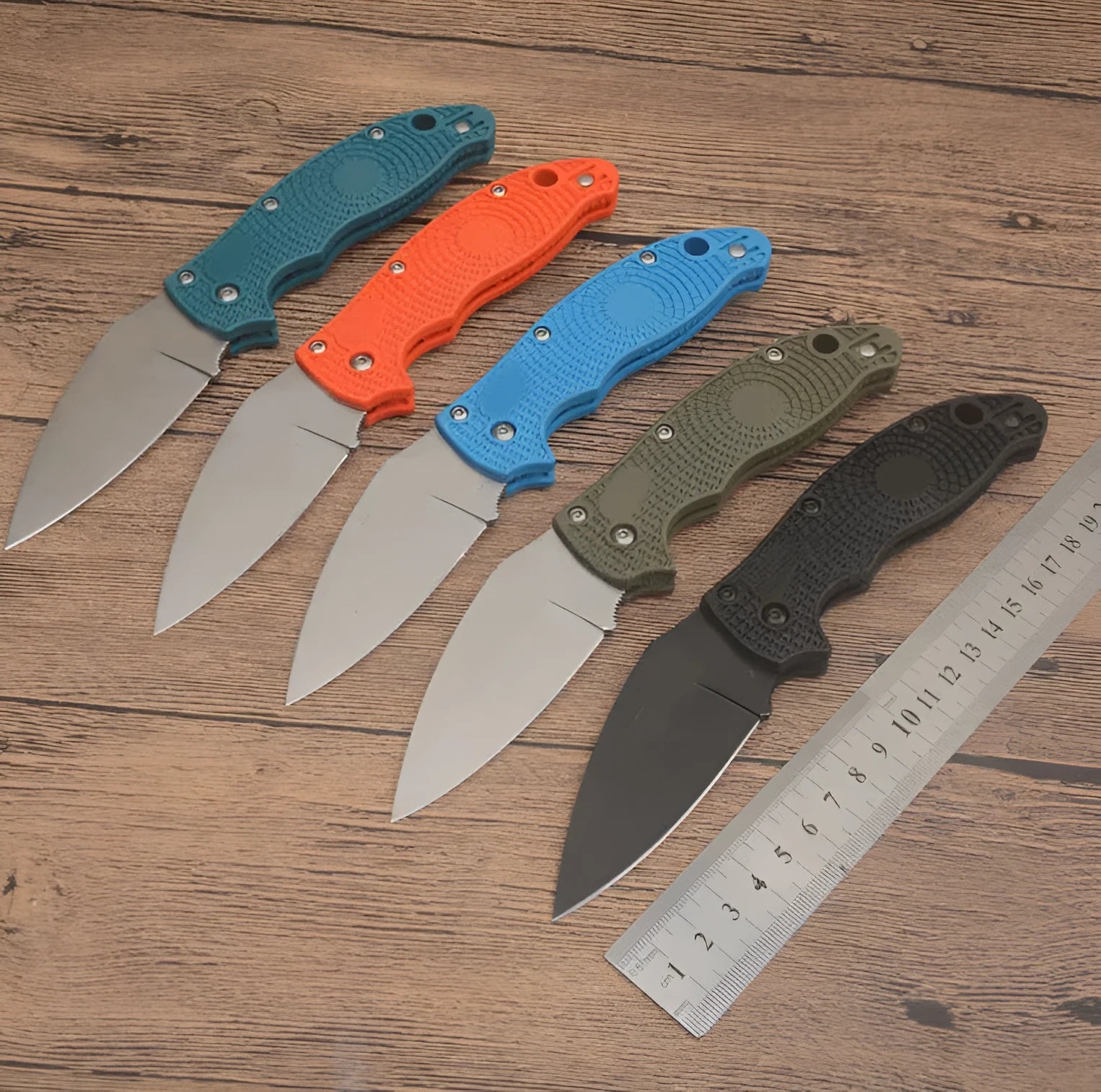 Portable folding fruit knife with black handle and silver 9CR13MOV blade on a wooden surface