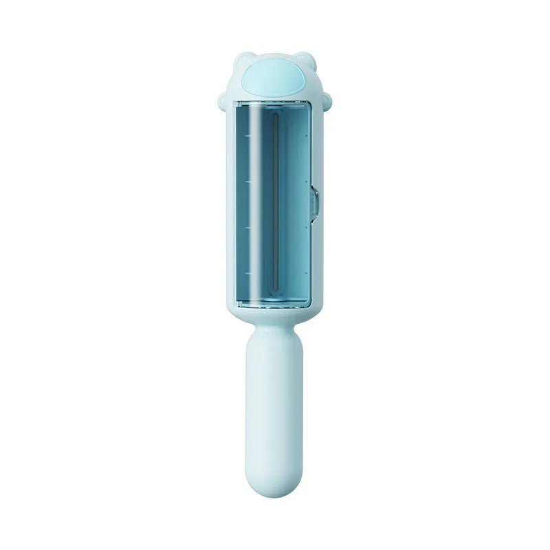 Blue reusable pet hair remover roller with self-cleaning base on a grey sofa.