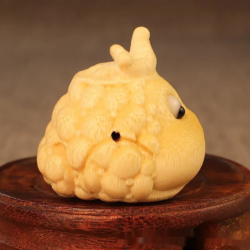 Solid bamboo carving of a cute Crown Princess Toad ornament, showing live eye detail.