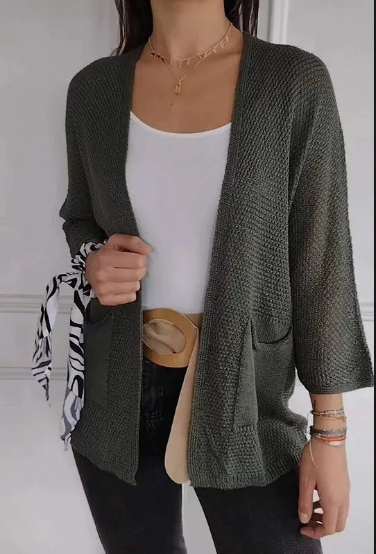 Women's army green waffle weave cardigan coat with nine-quarter length sleeves and pockets.