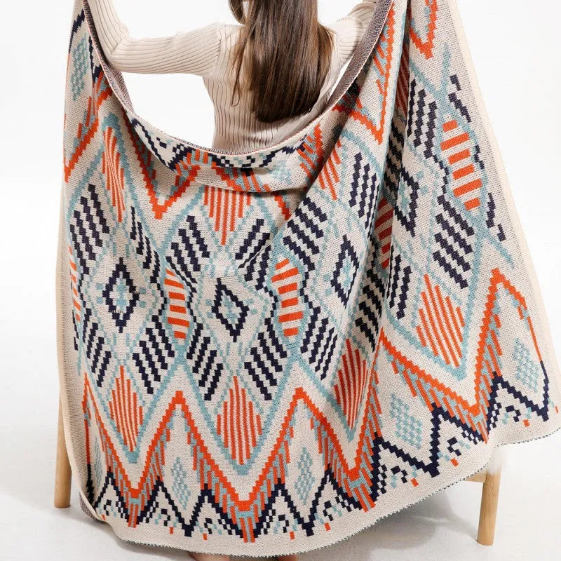 Acrylic sofa blanket with tassel fringe in geometric pattern, showing 130 cm width measurement