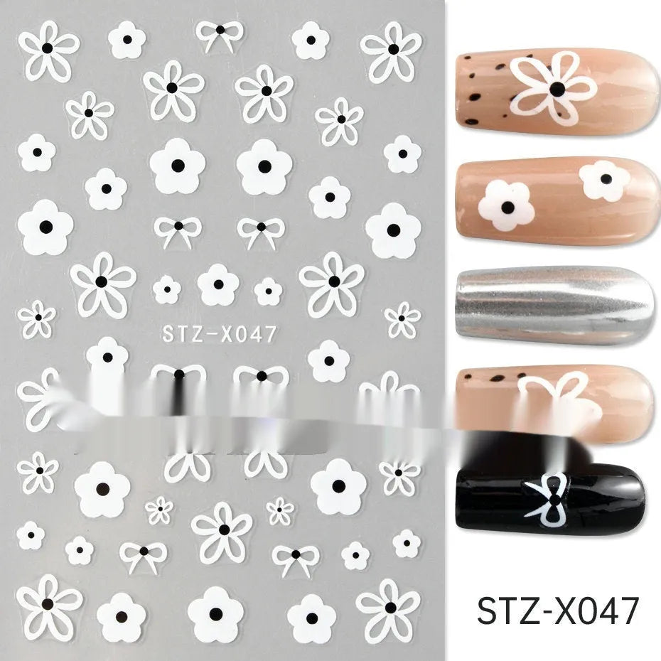 Sheet of black and silver strip nail art stickers with cartoon and love heart designs