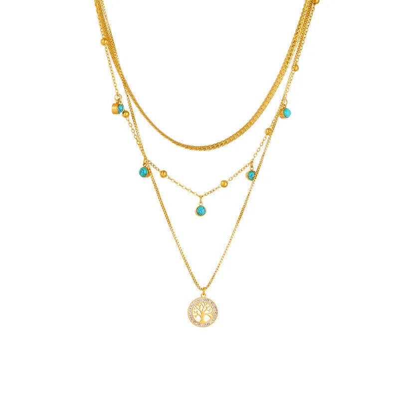 Gold-plated multi-layer stainless steel necklace with geometric tree pendant on woman