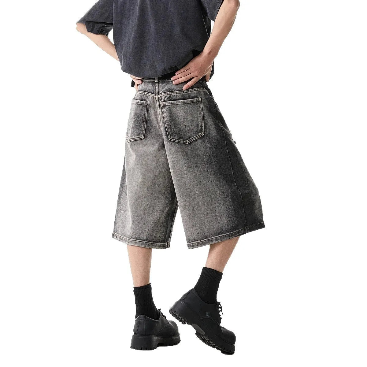 Grey cotton denim shorts with distressed hole finish and loose cropped fit