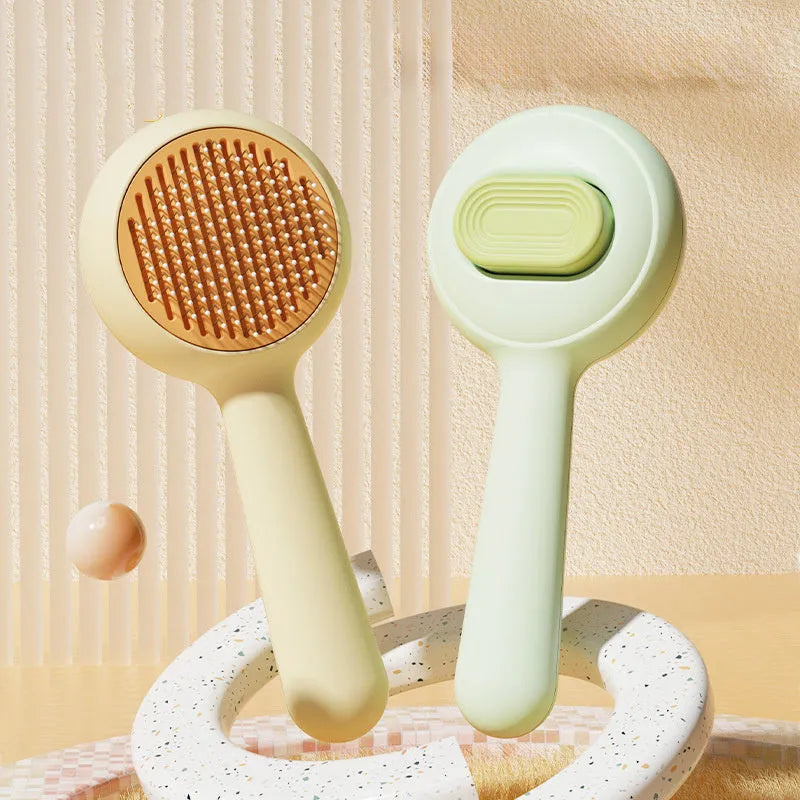 Green and yellow cat brush with stainless steel teeth and non-slip handle