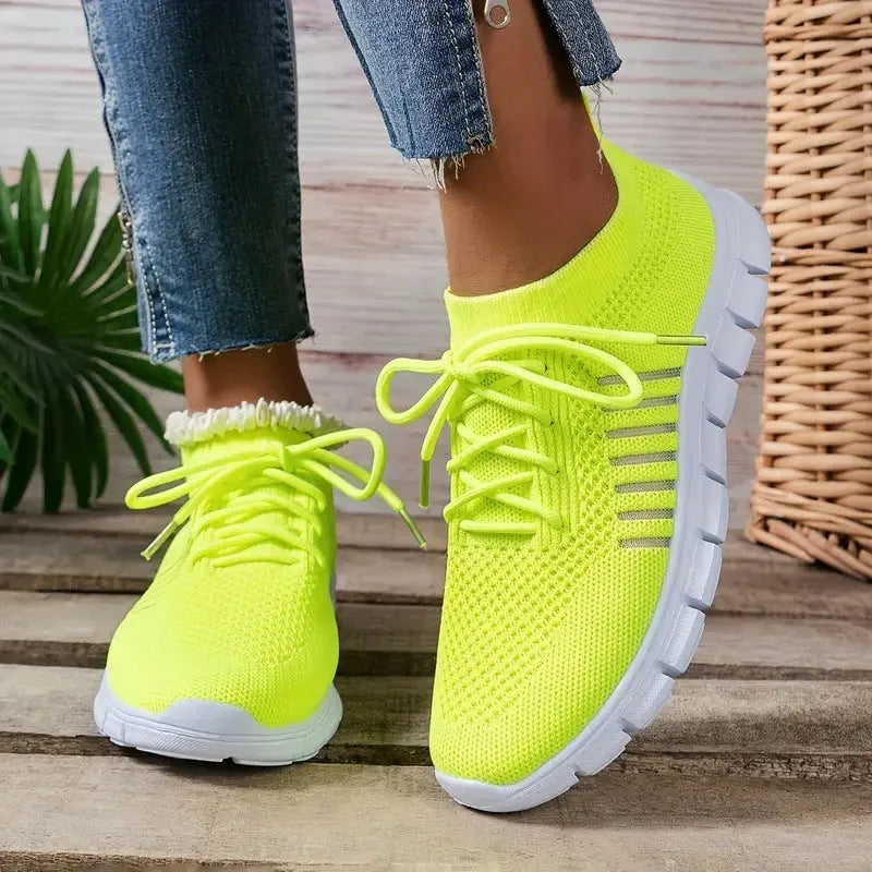 Women's casual breathable flying knit flat shoes in various colours on a white background.