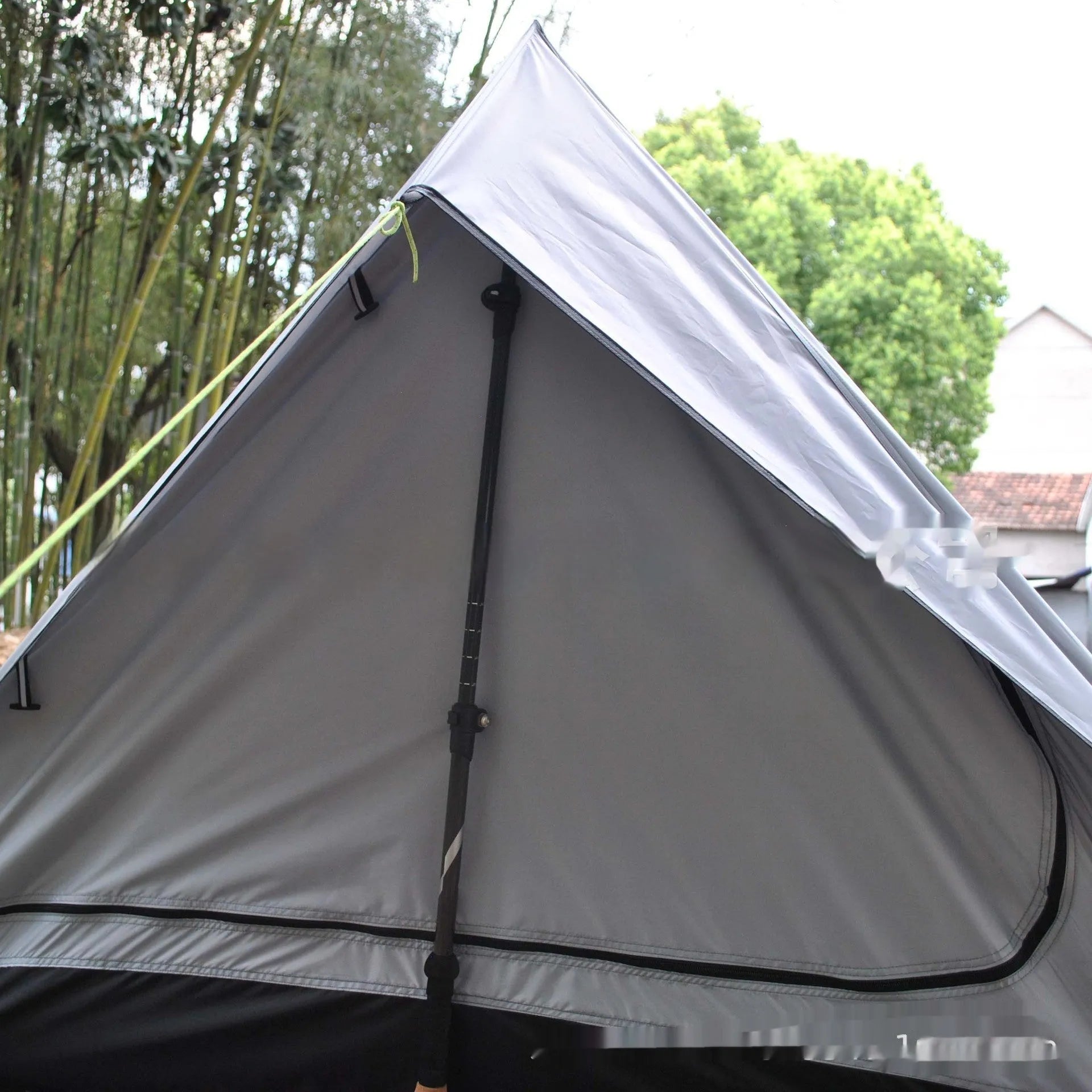 Brown or white A-line hiking tent pitched using hiking canes, showing spacious interior for 2-3 people.