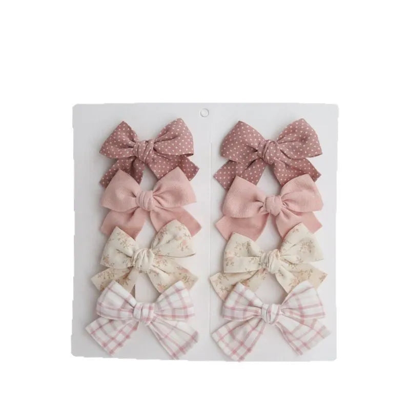 Children's cloth hairclips with dovetail bow decoration in multiple colour options