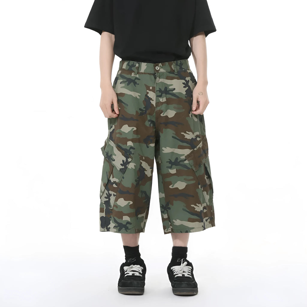 Men's camouflage coloured wide-leg cotton cargo trousers with large patch pockets and side stitching.