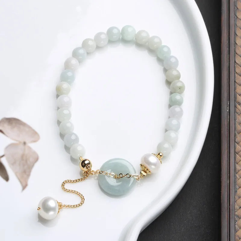 Natural emerald peace buckle pearl bracelet for women with jade round pendant on a geometric design.